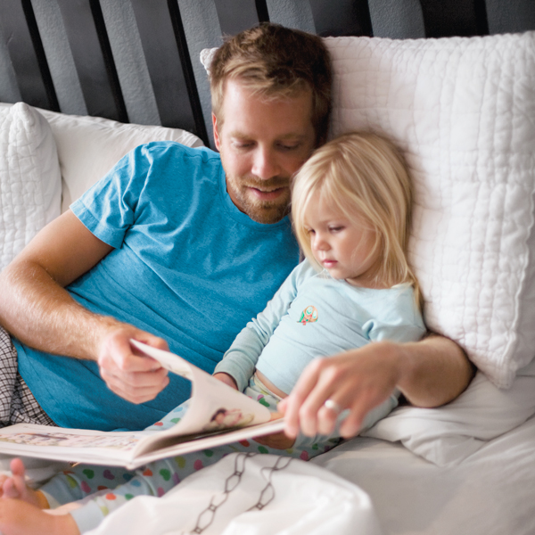Dad and daughter reading a book about gratitude