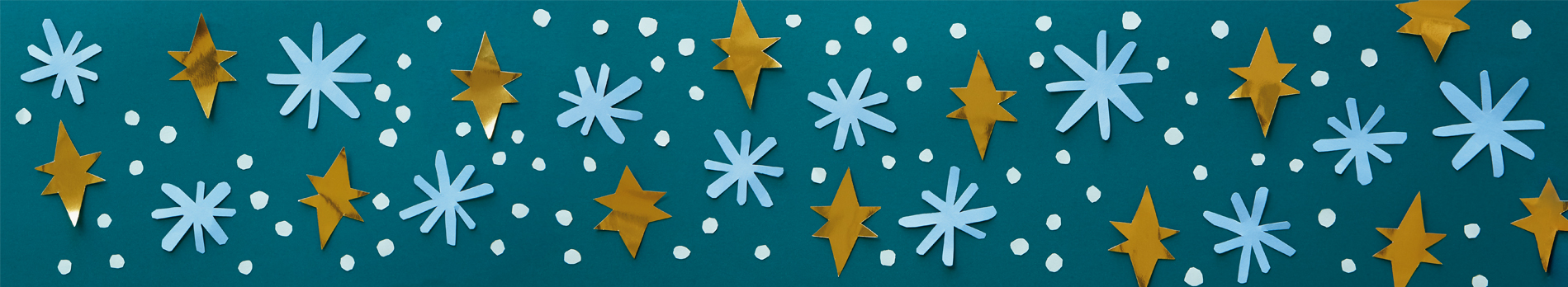 Winter background with paper cut snowflakes and stars on a dark green surface