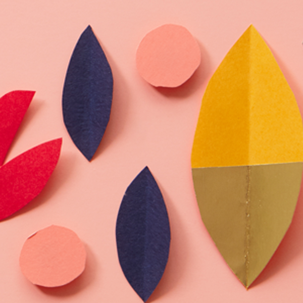 Paper cut fall leaves on a light pink surface