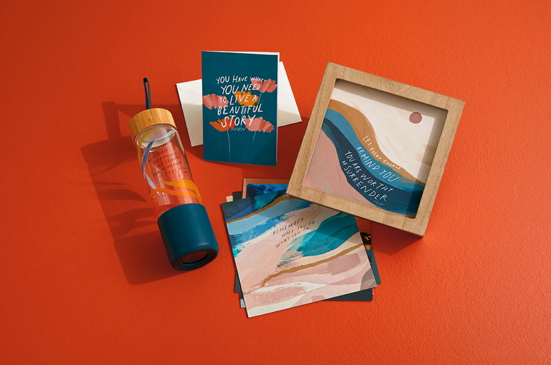 A grouping of products from the Morgan Harper Nichols Real Stories collection, including a greeting card, a water bottle, a framed sentiment, and prints.