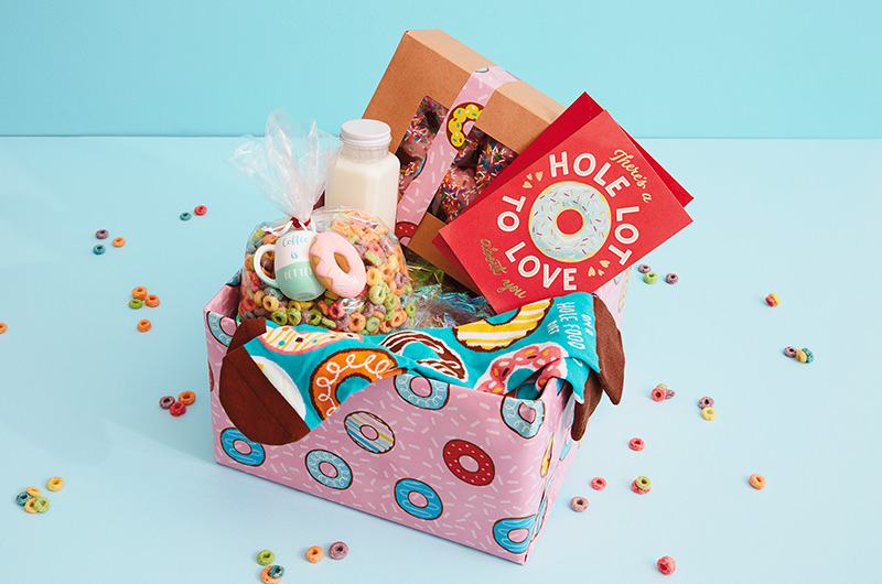 A Valentine's Day care package filled with donut-themed gifts.