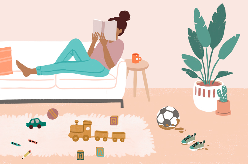 An illustration of a woman reading on her couch. The living room floor is scattered with toys, muddy shoes and a soccer ball.