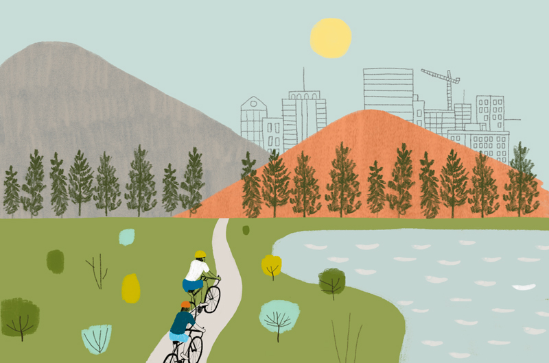 An illustration of two bicyclists riding on a lakeside path toward a set of hills; in the distance beyond lies a cityscape with the sun above.