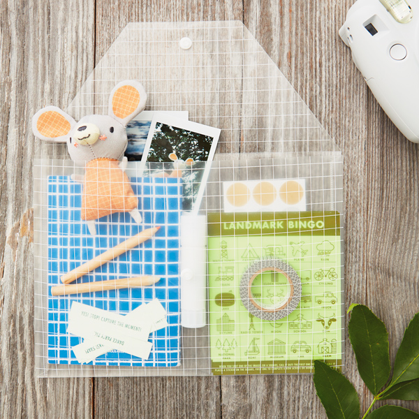 Hannah's DIY travel games kit, tucked inside a clear plastic pouch.