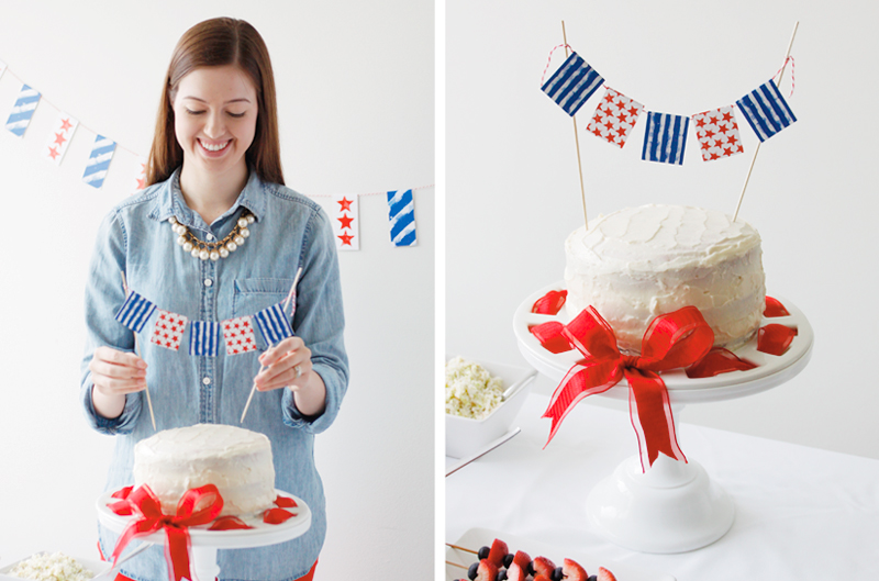 A woman placing a DIY Fourth of July cake topper on a white frosted cake.
