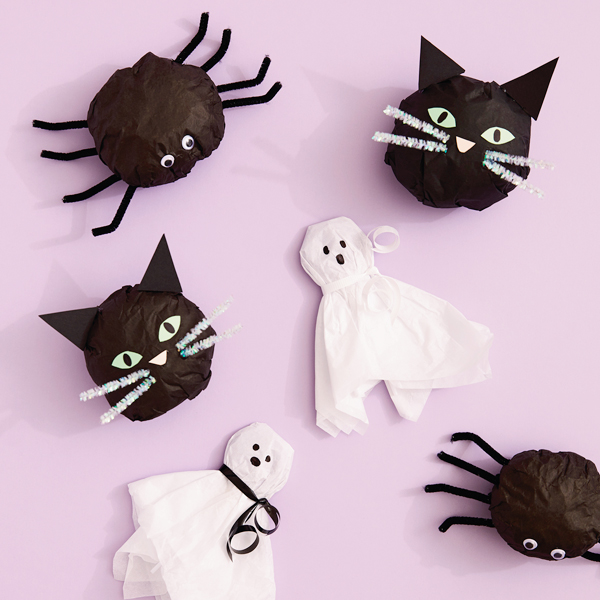 A variety of Halloween surprise tissue paper treats in the shapes of spiders, black cats and ghosts.