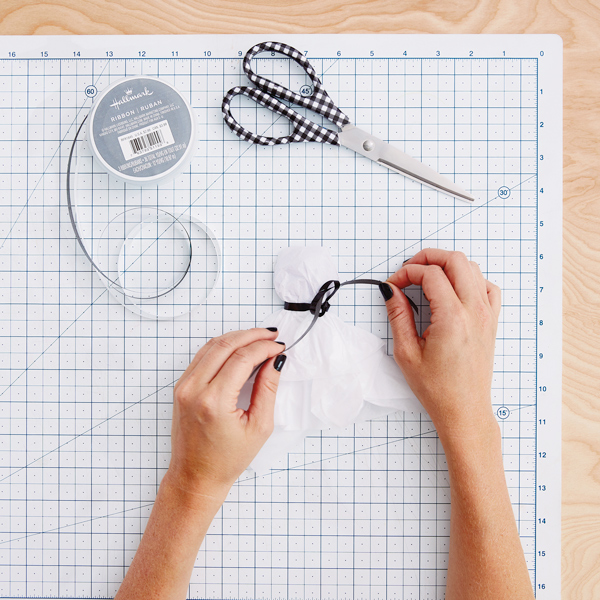 Halloween handmade decor. How to make funny paper bat. Cutting the shape  with scissors. Step 2. Top view, flat lay Stock Photo