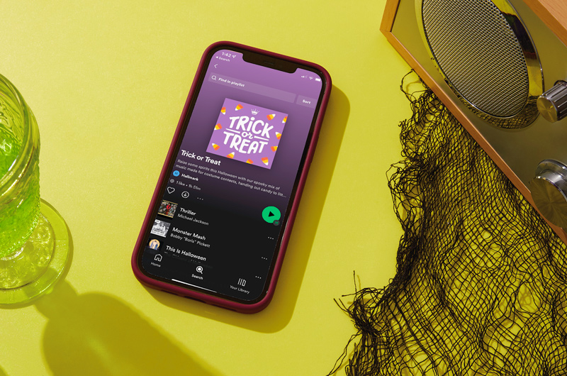 A smartphone showing a Hallmark Halloween playlist on Spotify called 