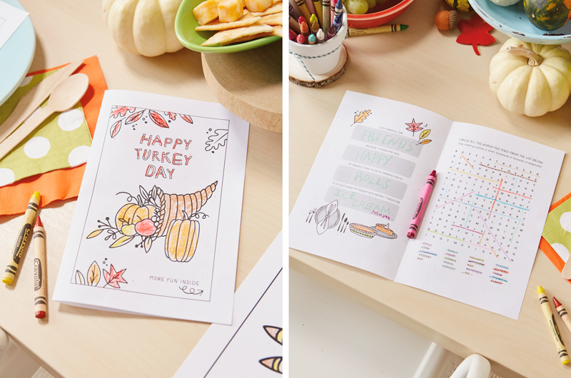 A kids Thanksgiving activity book surrounded by Crayola crayons.