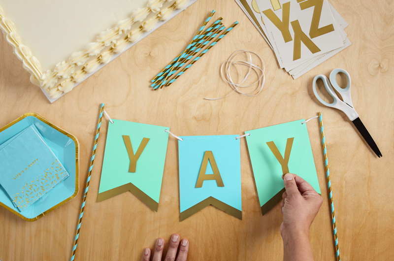 A DIY birthday banner cake topper that spells out 
