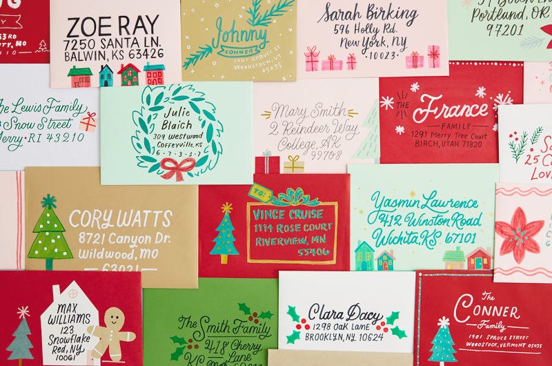A collage of envelopes that have been hand lettered and decorated with holiday icons such as trees, gingerbread men and wreaths.