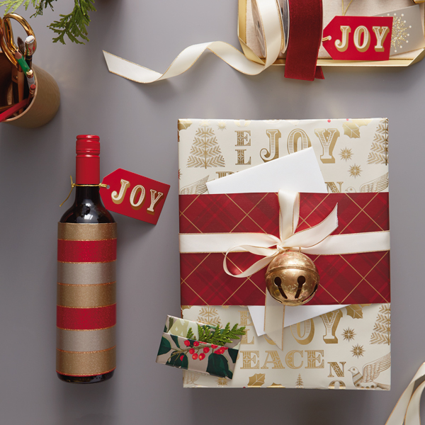 A trio of festively wrapped gifts meant for a holiday party host.