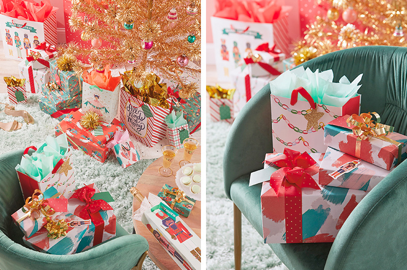 A number of gifts wrapped in vintage modern gift wrap and bags clustered around a gold tinsel tree.