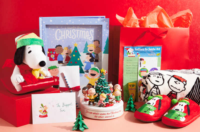 A Peanuts-themed Christmas care package containing a blanket, slippers, book, interactive plush and more.