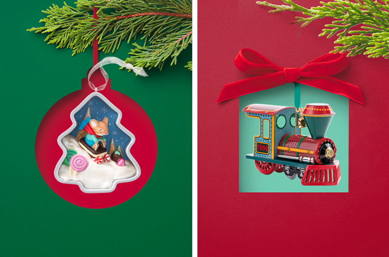 Two Keepsake Ornaments—one a diorama-like scene of a sledding mouse inside a Christmas tree-shaped cookie cutter, the other a detailed steam engine.