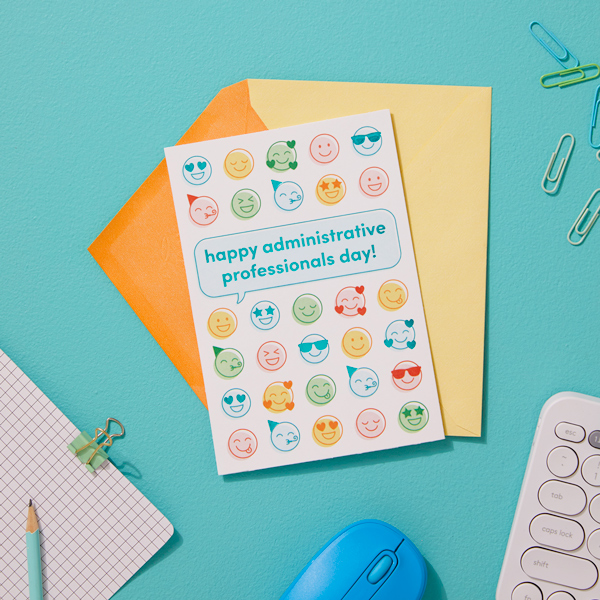 A card featuring a variety of happy emoji faces, with a speech bubble that reads, 