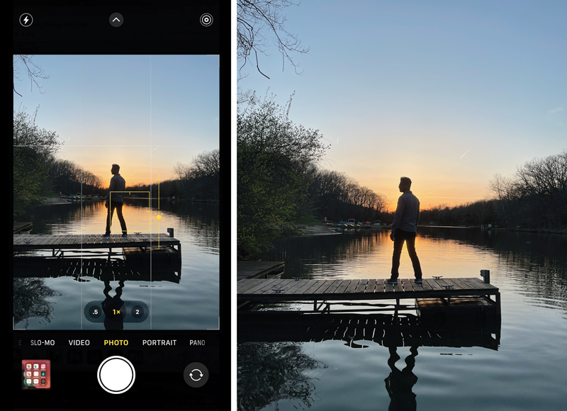 A scene of a man standing on a lakeside dock at sunset, as viewed within the iPhone camera app. The image is being used to demonstrate how to work with light in photos, as placing the man between the camera and the sunset creates a very dark silhouette against a brightly lit sky.