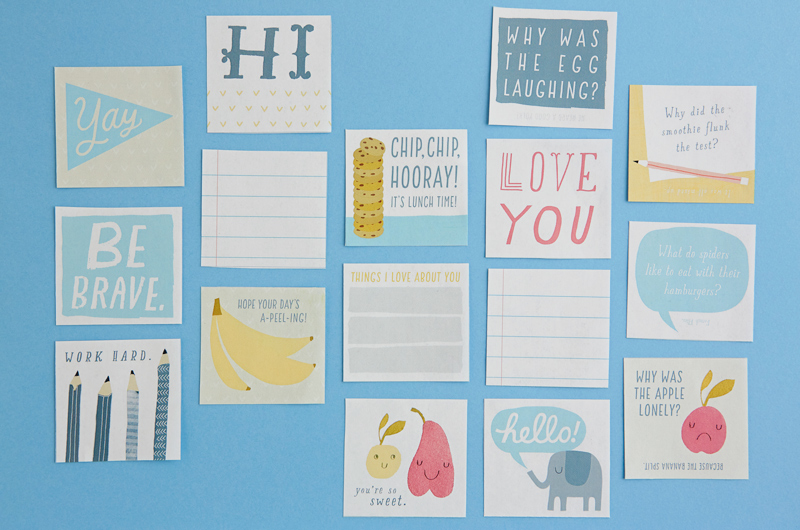 All of the lunchbox notes from our free printable have been cut out and arranged in a grid pattern on a light blue surface.