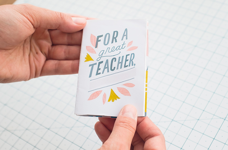 A pair of hands holds the finished teacher appreciation zine.