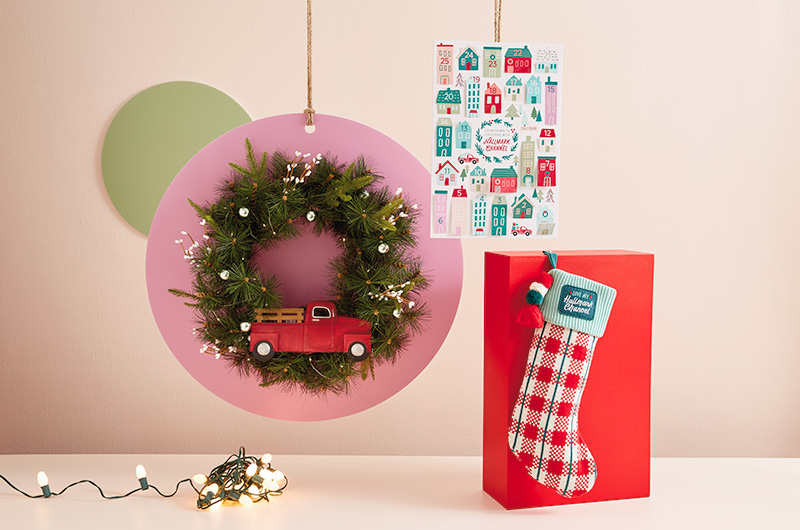 Hallmark Channel gift ideas for the one who's all about making magic at the holidays include a Hallmark Channel stocking, a Christmas countdown calendar, and a light-up wreath featuring an iconic red pickup truck.