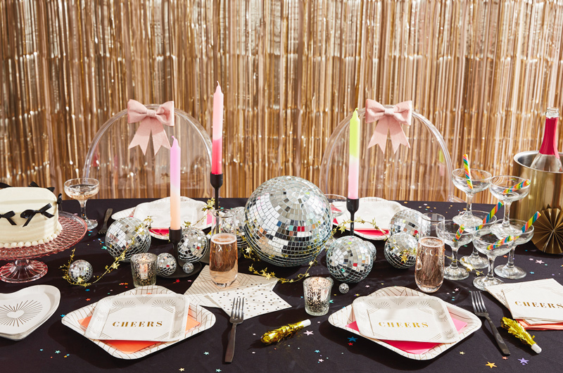 A New Year's Eve tablescape featuring Hallmark Celebrate! partyware, like cream-colored cocktail napkins that have 