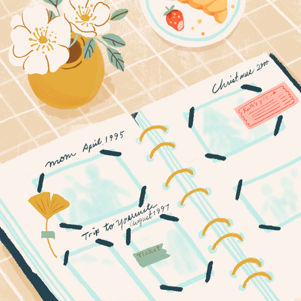 An illustration of the inside of a scrapbook filled with ticket stubs, recipes, photos, pressed flowers and handwritten notes, sitting on a checkered tablecloth with a flower vase nearby.