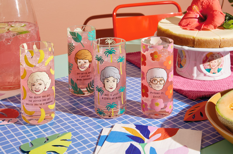 A set of four drinking glasses, each featuring an illustration of a different main character from TV's 