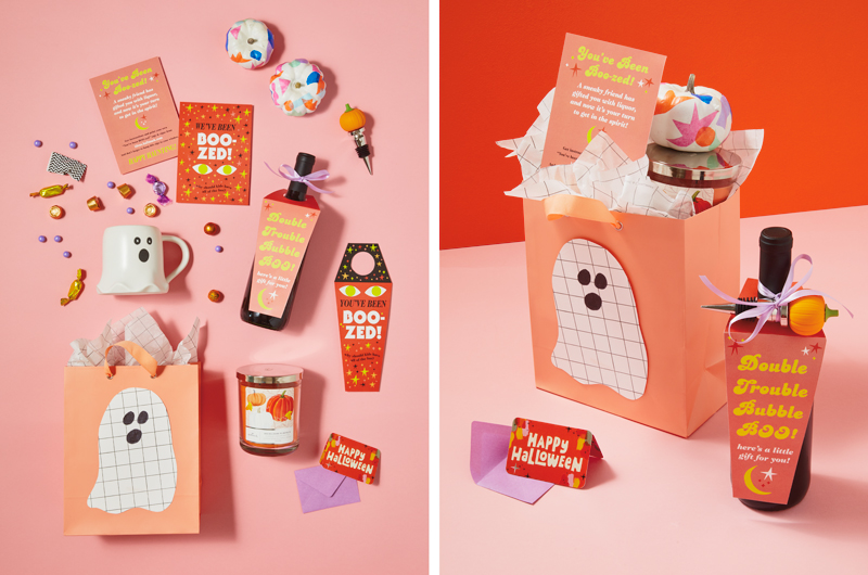 A boozy Halloween boo bag kit for an adult that includes a bottle of wine with a free printable attached, a pumpkin-spice scented candle, a mug shaped like a cute little ghost, a handful of candy, a mini card that reads, 