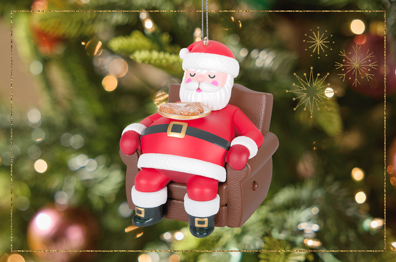 A Keepsake Ornament that depicts Santa Claus sleeping in a recliner with a plate of Christmas cookies on his chest; the ornament is animatronic and when a button on the side of the recliner is pressed, Santa's belly rises and falls with his breath and the sound of his snores can be heard.