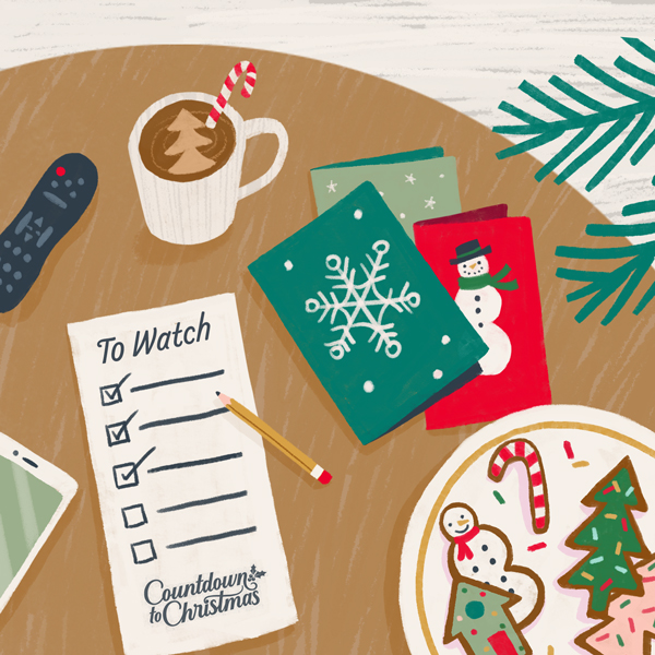 An illustration of a coffee table set with holiday items like decorated sugar cookies, a mug of cocoa, holiday cards, and a 