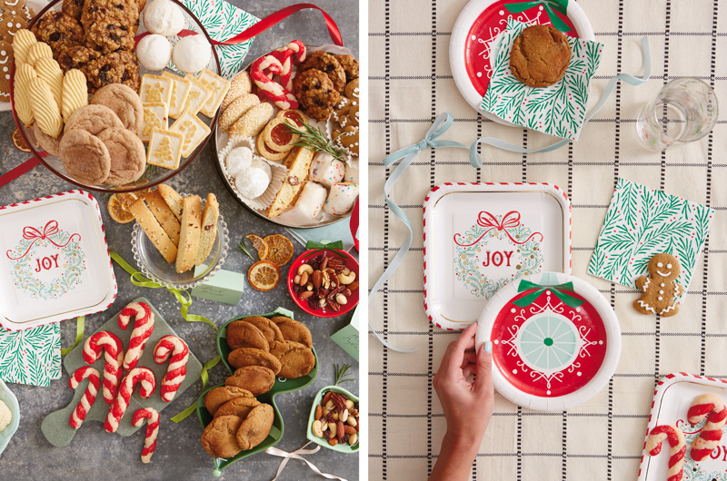 A stone countertop is covered with tins, bowls, serving dishes and platters that are filled with various kinds of Christmas cookies; next to this is a table setting that features Hallmark's Celebrate! partyware line of paper plates and napkins in holiday patterns.