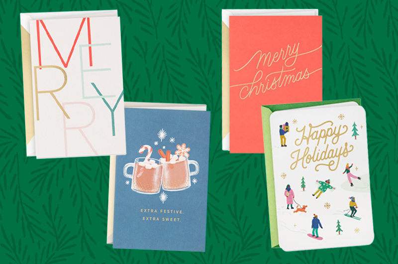 A collection of Hallmark holiday cards on an illustrated background of evergreen branches.