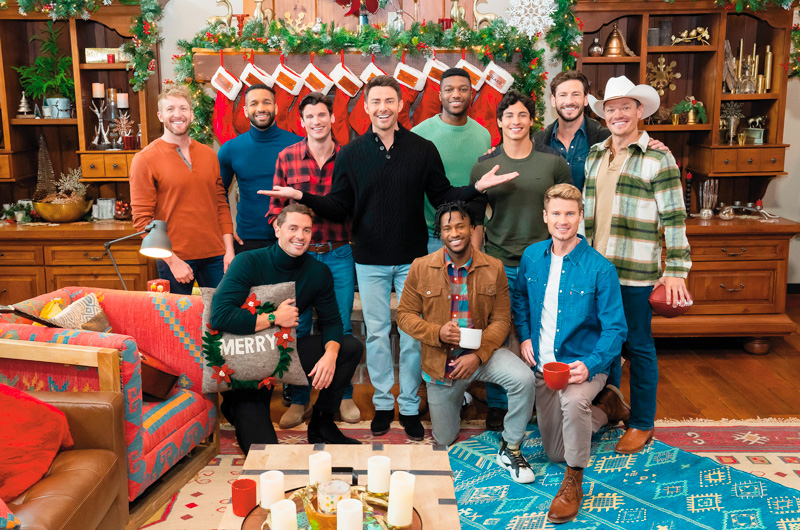 Actor Jonathan Bennett stands at the center of a group of the 10 men vying for the title of Mr. Christmas on the new Hallmark Plus show, 