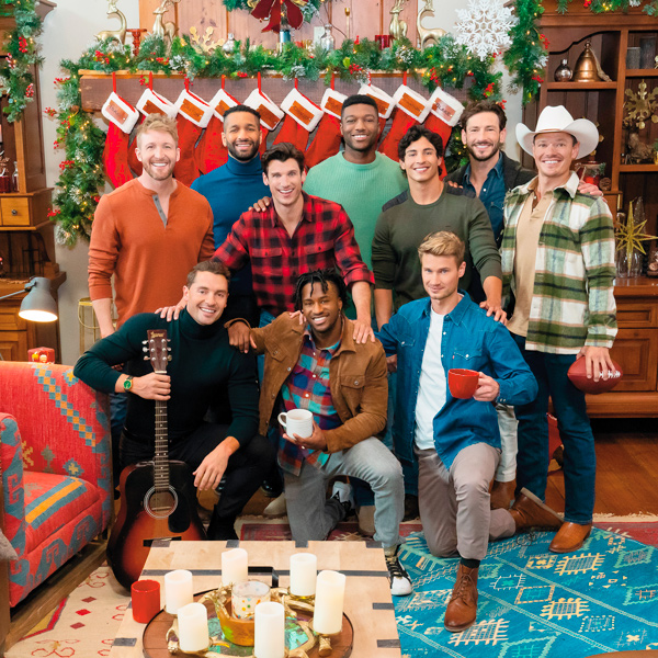 Ten men stand on the set of the new Hallmark Plus reality show, 