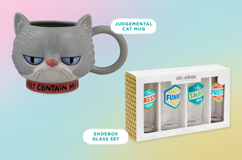 A figural mug in the shape of a grumpy-faced cat with a base that reads, 