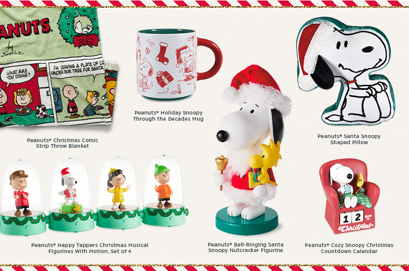 A collection of Peanuts holiday gifts, including a plush blanket, a set of interactive Peanuts figurines that tap along to music; a nutcracker figurine of Snoopy dressed as a bell-ringing Santa; a Christmas countdown calendar in the form of Snoopy and Woodstock sitting in a chair, all cozy with mugs of cocoa and a plaid blanket; a pillow shaped like Snoopy wearing a Santa hat; and a holiday Snoopy Through the Decades mug.