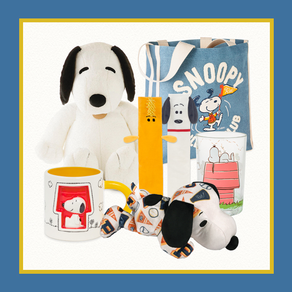 A collection of Peanuts Snoopy-themed gifts including a jumbo Snoopy plush, a floppy Snoopy plush covered in sports icons, a drinking glass, a pair of novelty socks, a mug and a tote bag.