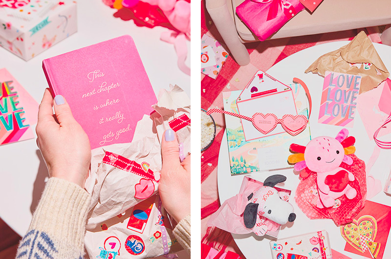 A woman's hands hold a pink journal with the words, 