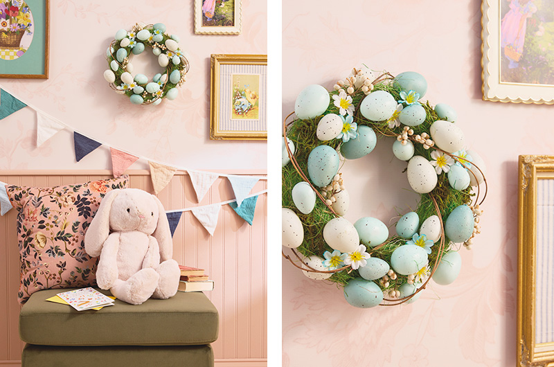 A Nancy Meyers-inspired Easter decor scene, with warm, neutral colors and ecclectic personal elements in soft pastels, including a soft pink stuffed bunny, a salmon pink pillow covered in a dark neutral floral pattern; a wreath made of moss, twigs, and small faux speckled eggs in shades of light blue and white.