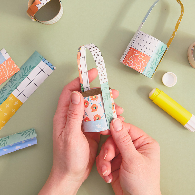 A woman's hands apply a handle to her DIY individual egg 