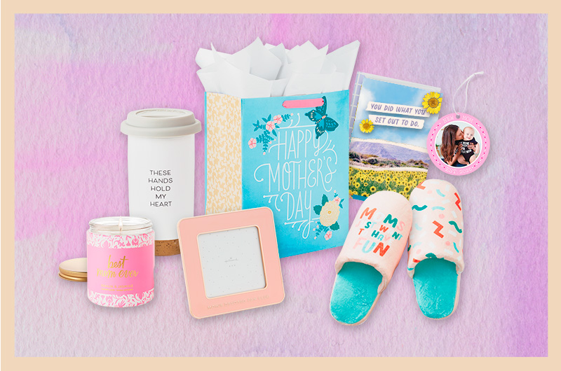 A selection of first Mother's Day gift ideas for a sister of a new mom that includes a set of fuzzy slippers, the left of which reads, 