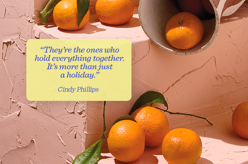 Fresh oranges sit on a set of steps that have been coated in a peach-colored plaster; on top of this background is a yellow text box with a pull quote attributed to Hallmarker Cindy Phillips that reads, 