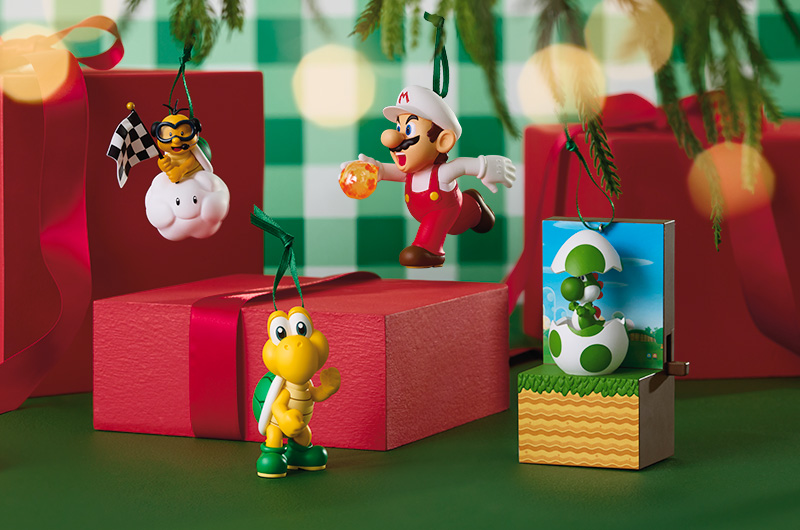A collection of Keepsake Ornaments featuring characters from the Super Mario Bros. franchise, including Fireball Mario, Yoshi, and a Koopa Trooper.