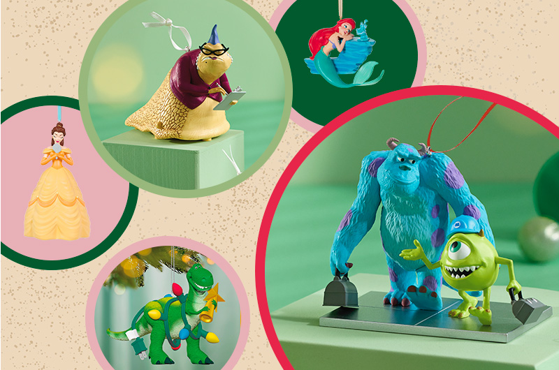 A collection of Disney Keepsake Ornaments featuring beloved characters like Ariel from The Little Mermaid; Belle from Beauty and the Beast; Rex from Toy Story; Mike and Sully from Monsters Inc.; and Roz, also from Monsters Inc.