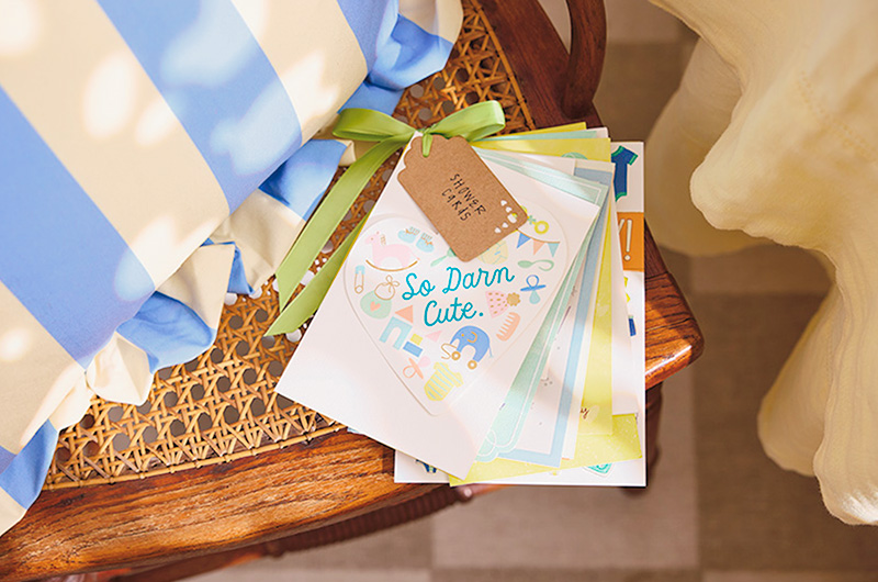 A bundle of cards have been hole punched in the upper left-hand corner and strung onto a bright green ribbon with a tag that reads 