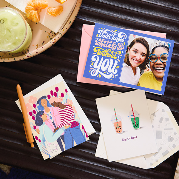 A trio of friendship cards are laid out on a coffee table next to a snack tray.