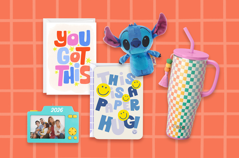 A collection of back-to-school gifts for kids from parents, including a little Disney Stitch plush, an insulated drink tumbler, Just Because greeting cards with encouraging messages like 