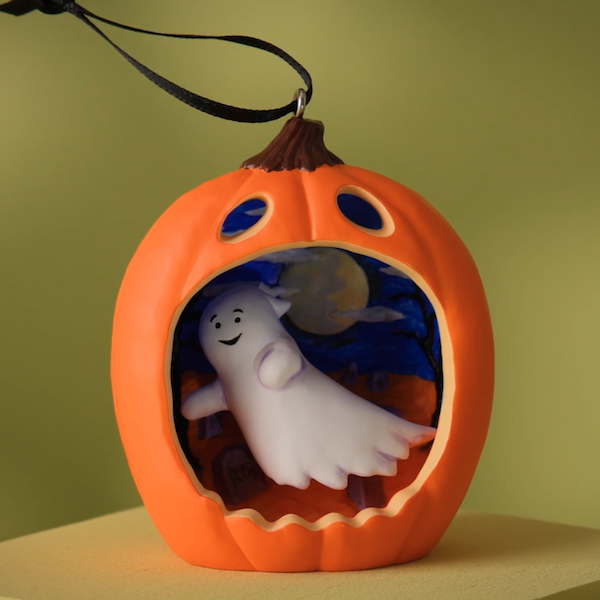 A sculpted Halloween Keepsake Ornament featuring a diorama of a friendly looking ghost inside the yawning mouth of a jack-o-lantern.